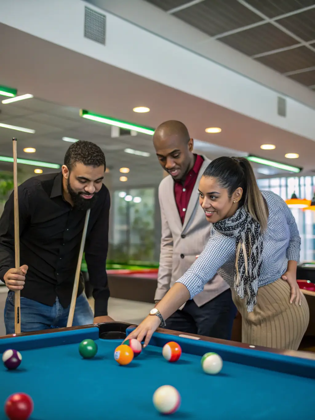 A group of diverse individuals participating in a billiards training session, led by a certified FFB instructor, emphasizing inclusivity and skill development.